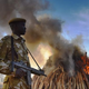 A KWS security officer stands near a burning pile of 15 tonnes of elephant ivory seized in Kenya at Nairobi National Park on March 3, 2015.
CARL DE SOUZA/AFP/Getty Images